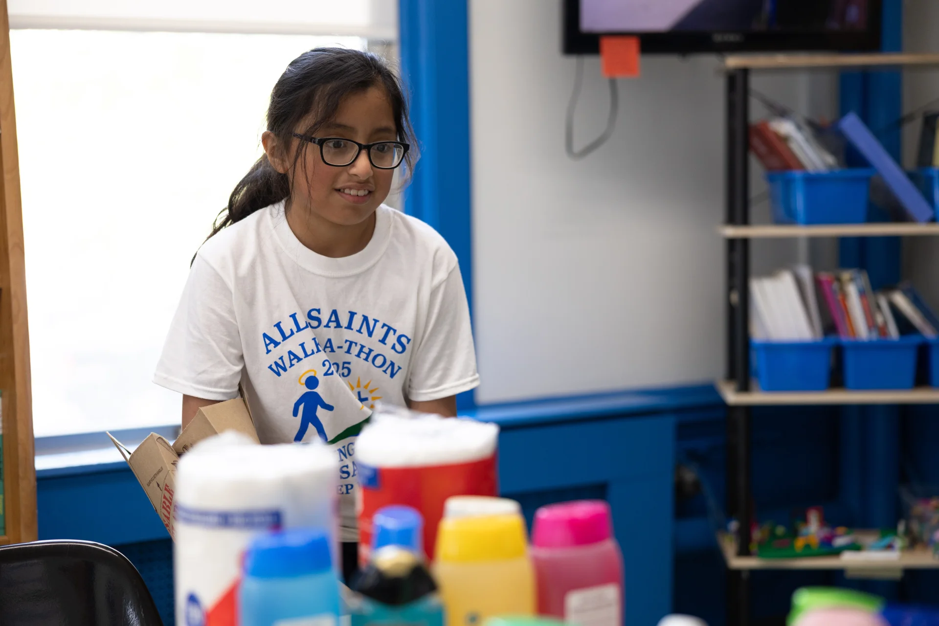 student packing toiletry donations for service project