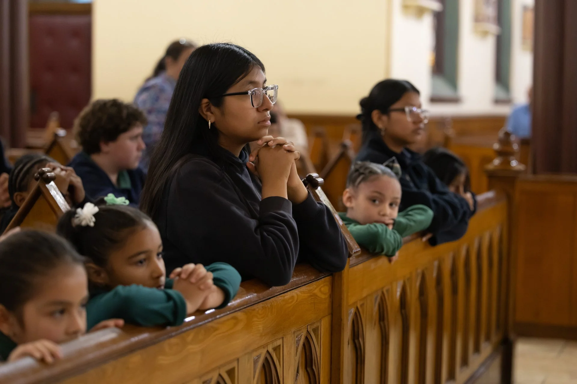 students kneeling and praying