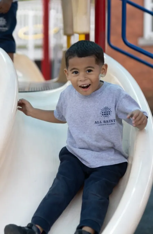happy student on outdoor slide