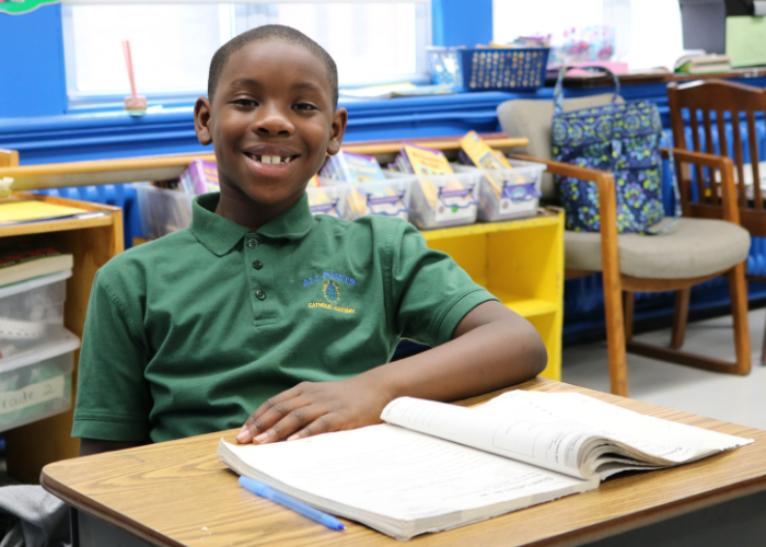 Student reading in a tent