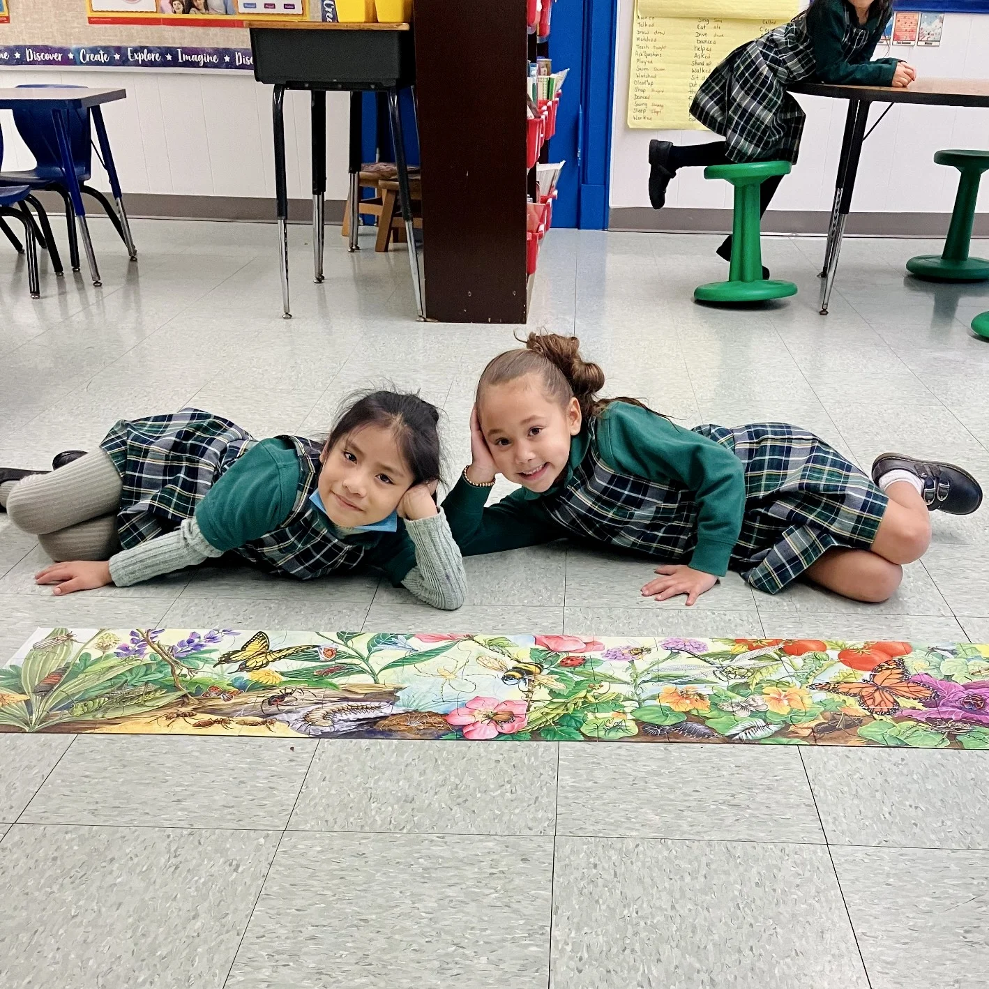 atudents smiling with completed puzzle