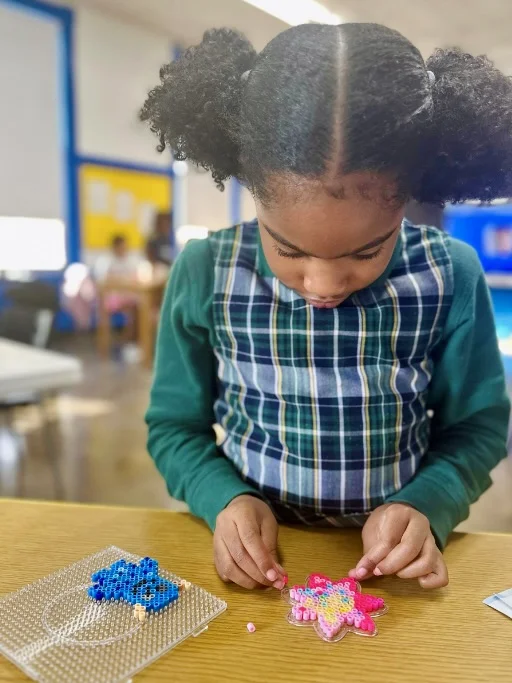 student working on beading project