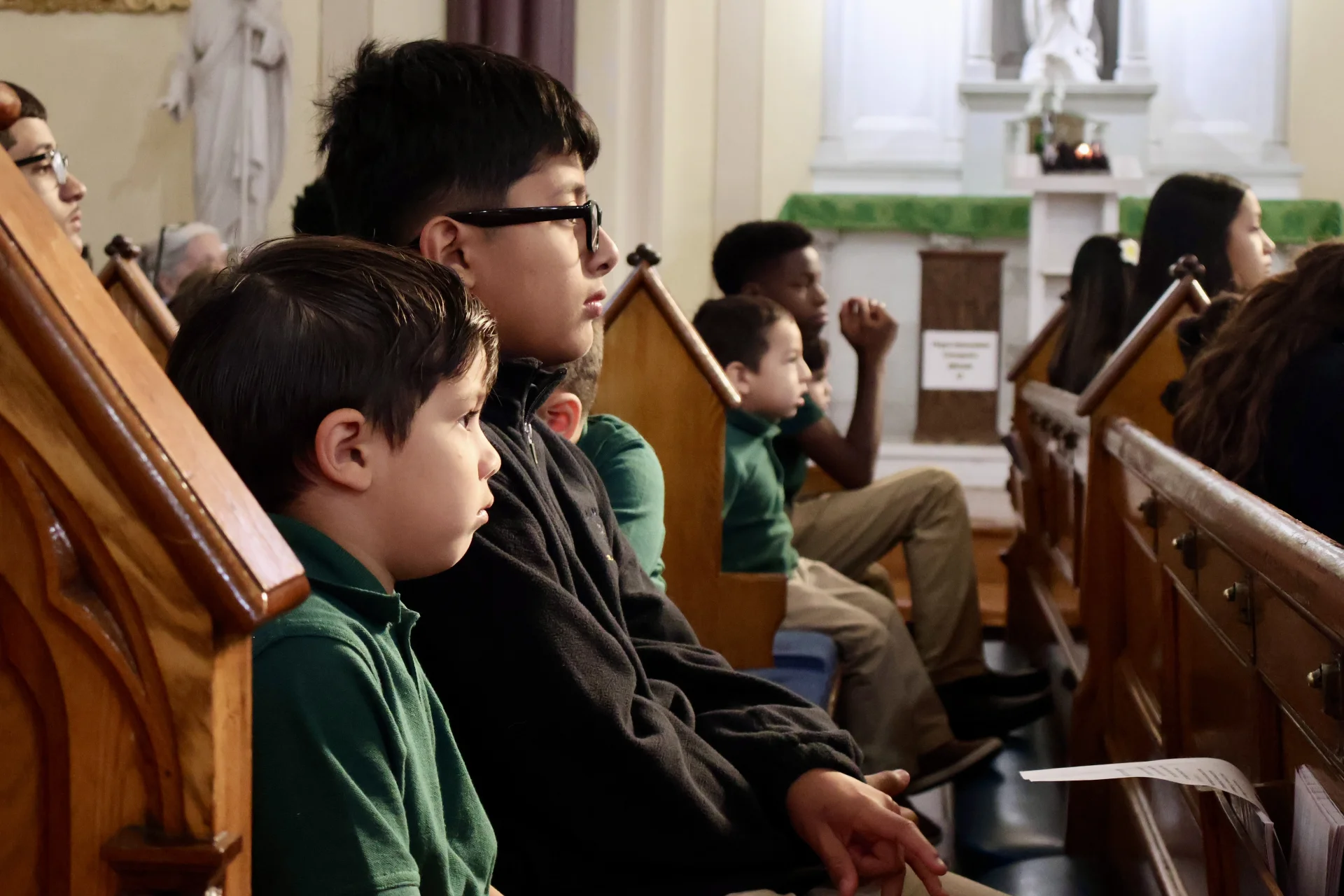 students sitting at Mass